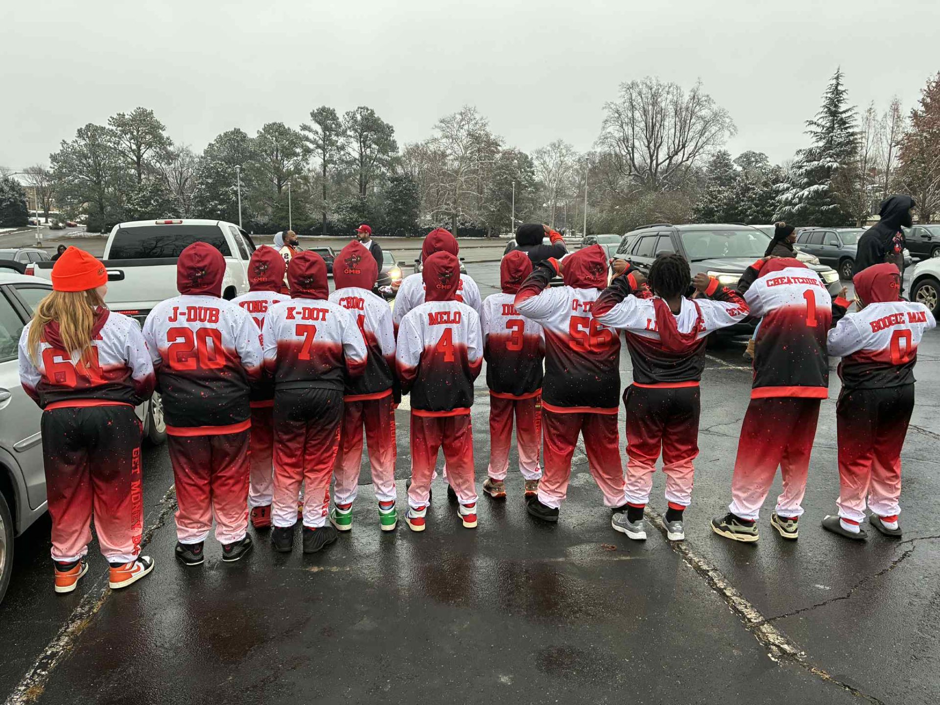 Parents in matching custom Gameday tracksuits